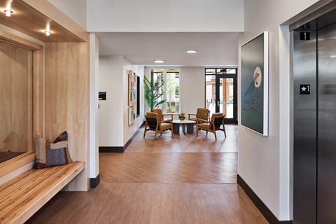 a living room with wooden floors and a table and chairs